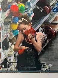 Store camera still showing the red bandana and white sunglasses described in the report