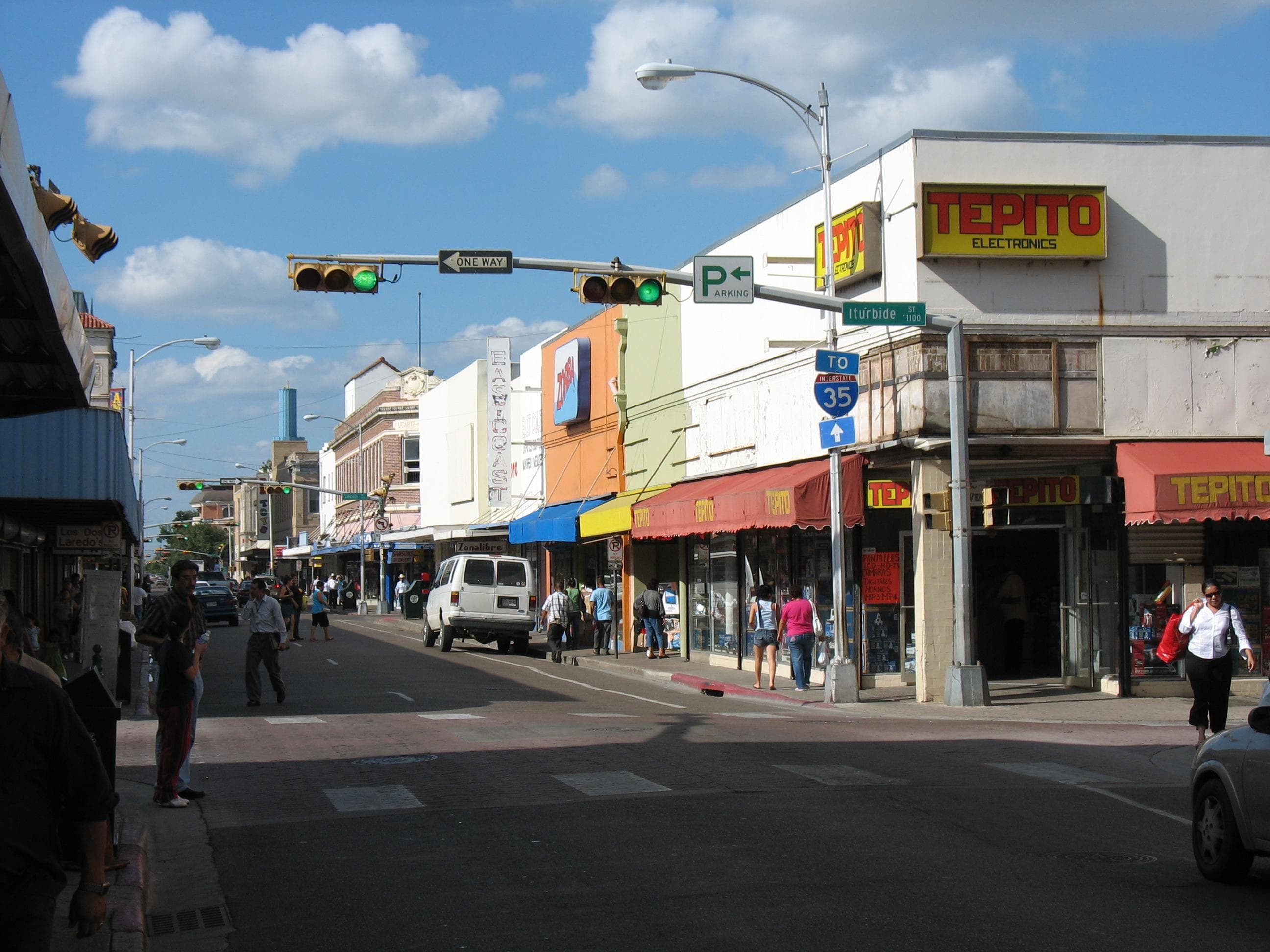 Historic storefronts and street traffic in downtown Laredo, Texas